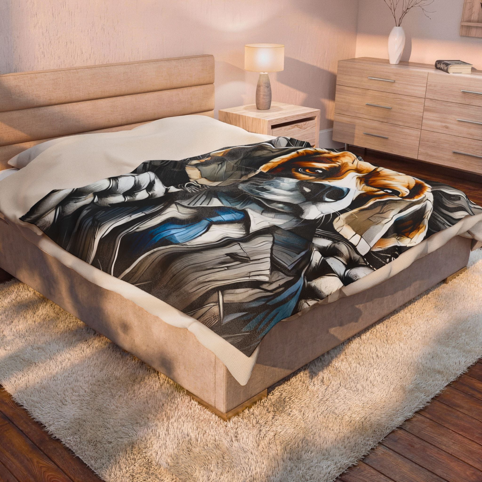 A bed in a modern bedroom setting, featuring a colorful graphic print blanket with a stylized beagle face design in black, white, gray, and blue.