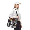 A woman wearing a white cap, white sweatshirt, and black pants carries a canvas tote bag featuring a printed graphic of a beagle dog in a suit sitting in a car. The background is solid white.