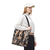A woman wearing a white cap, white sweatshirt, and black pants carries a canvas tote bag featuring a printed illustration of along haired dachshund dog in a camouflage hoodie against a smoky gray background.