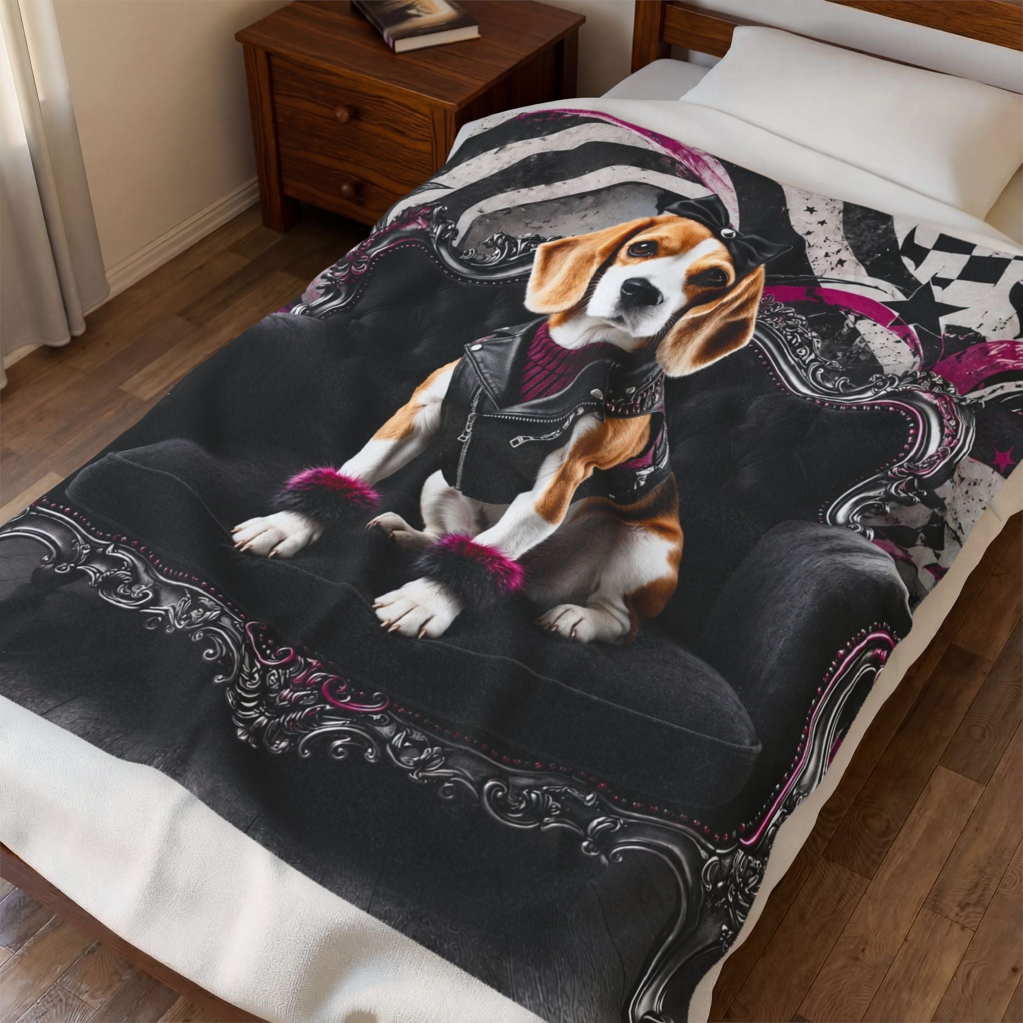 A printed blanket on a bed in a bedroom, featuring a beagle wearing a black leather jacket and pink wristbands, sitting on a black gothic-style chair with ornate silver scrollwork. The bedding includes a black comforter and white pillows/bedding.