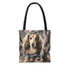 A tote bag with black handles featuring a printed illustration of a long-haired dachshund wearing a camouflage outfit and bow, set against a plain white background.