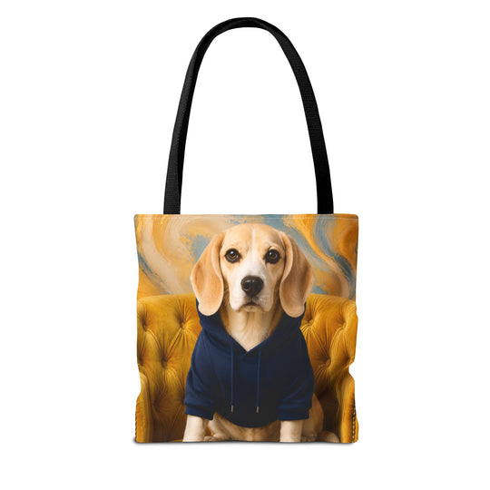 A tote bag with black handles, featuring a printed graphic of a beagle dog wearing a navy blue hoodie, seated on a tufted yellow armchair against a swirling gold and blue background.