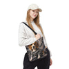 A woman wearing a beige cap, white hoodie, and black sweatpants carries a black shoulder bag featuring a printed graphic of a beagle dog in a camouflage jacket against a smoky gray background.