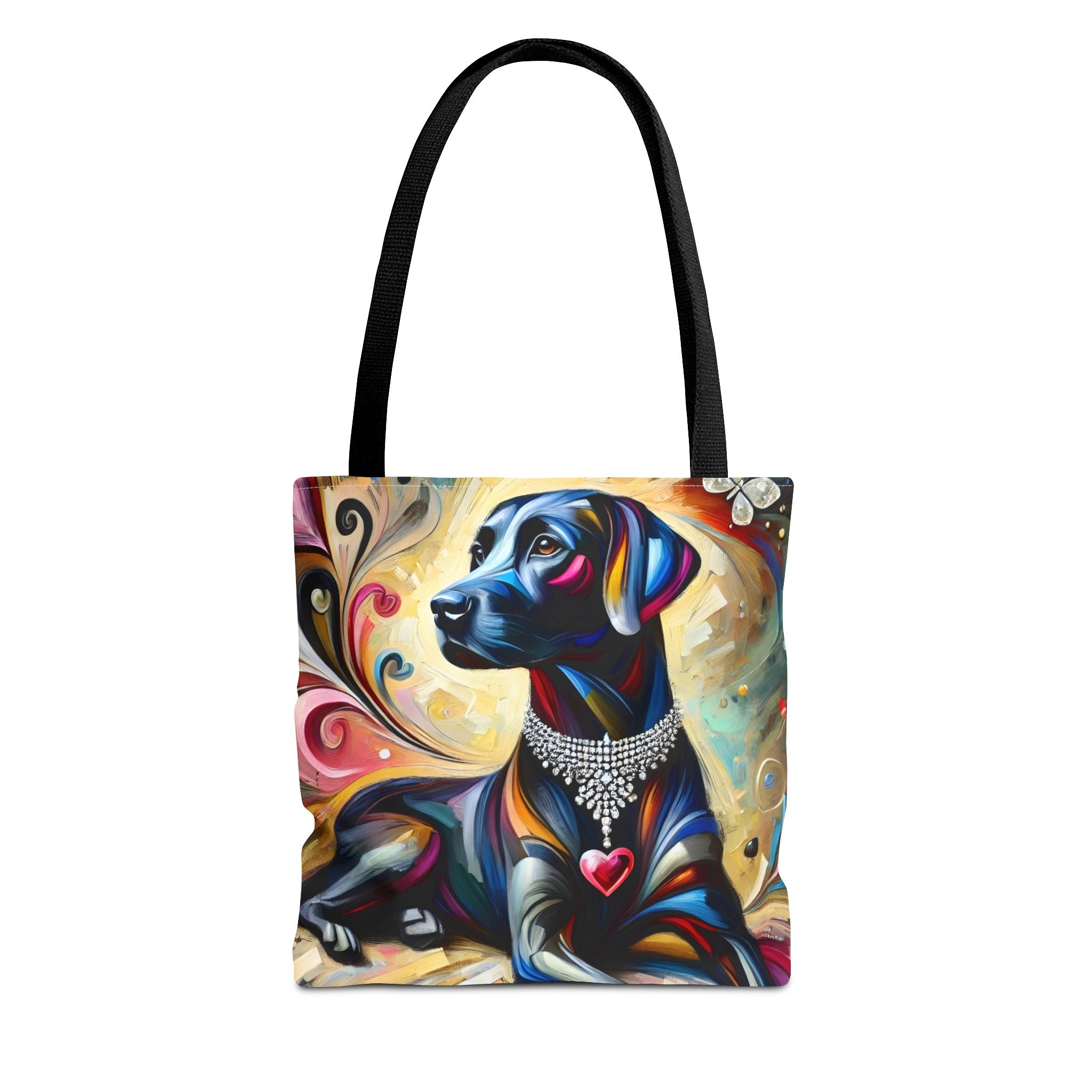 A tote bag with black shoulder straps, featuring a colorful artistic print of a black Labrador retriever wearing a jeweled collar and a red heart-shaped tag, set against a plain white background.