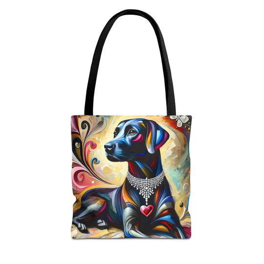 A tote bag with black shoulder straps, featuring a colorful artistic print of a black Labrador retriever wearing a jeweled collar and a red heart-shaped tag, set against a plain white background.