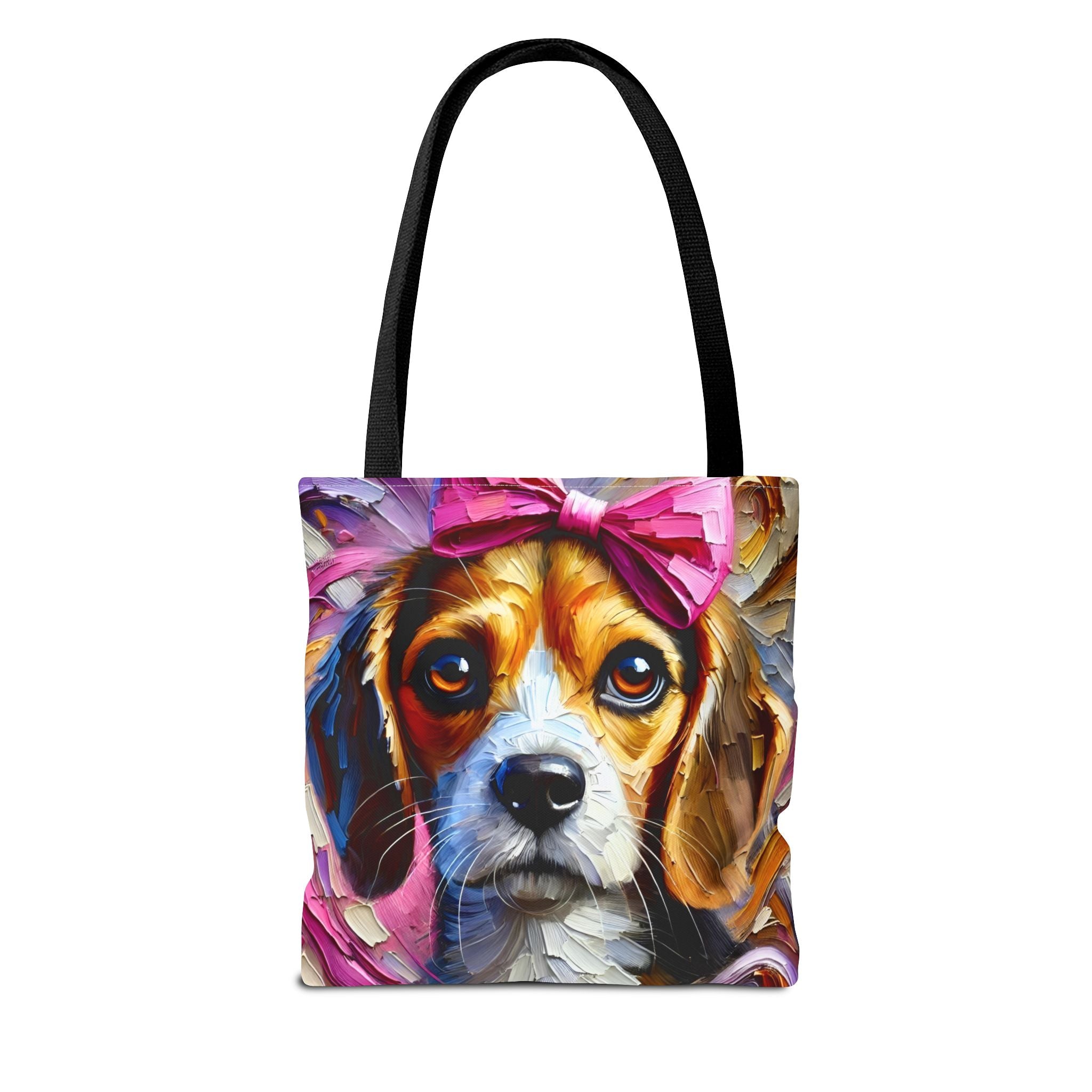 A tote bag with black handles, featuring a colorful, textured painting of a beagle dog wearing a pink bow on the front, set against a plain white background.