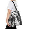 A woman wearing a white t-shirt and black pants carries a black shoulder tote bag featuring a detailed black and white graphic illustration of a  Labrador retriever in a suit.