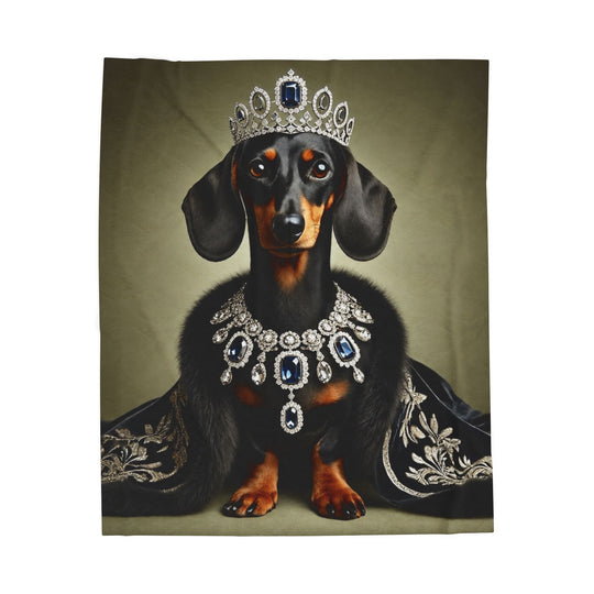 A blanket featuring a dachshund dressed as royalty, wearing a jeweled crown and necklace with a dark embroidered robe, centered on a muted olive background.