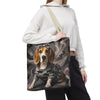 A person wearing a white cropped hoodie and black sweatpants carries a canvas tote bag. The bag features a printed illustration of a beagle dog wearing a gray camouflage sweater and a small bow against a smoky gray background.