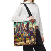 A person wearing a white hoodie and black sweatpants carries a large tote bag over their shoulder. The tote bag features a colorful, artistic print of a Boston Terrier dog in front of a city skyline, with a black shoulder strap.