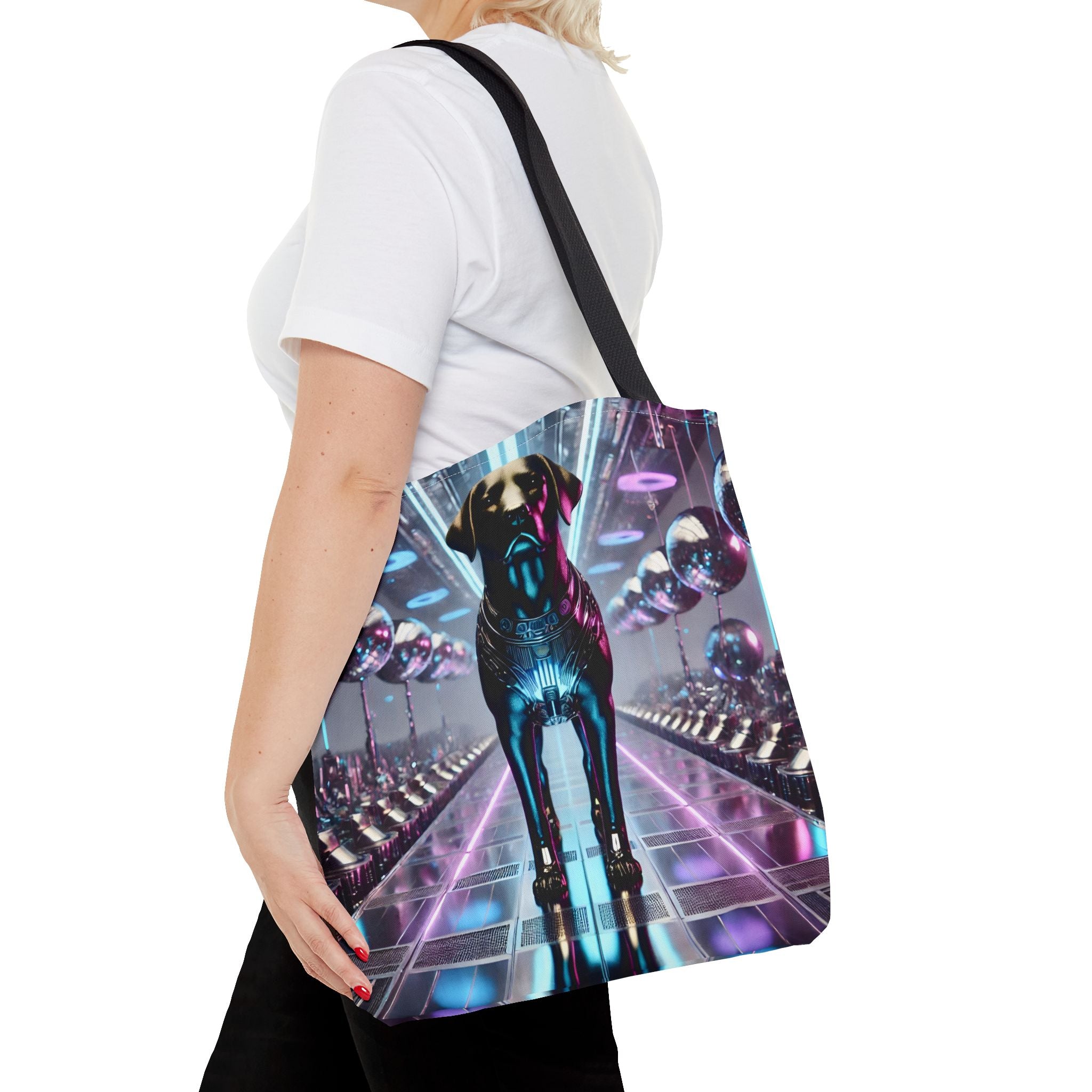 A woman wearing a white t-shirt and black pants carries a canvas tote bag over her shoulder. The bag features a vibrant, colorful graphic print of a futuristic Labrador retriever in a neon-lit tunnel, with a black shoulder strap.