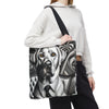 A person wearing a white hoodie and black sweatpants carries a black shoulder bag featuring a detailed black and white graphic illustration of a  Labrador retriever wearing a suit and tie.