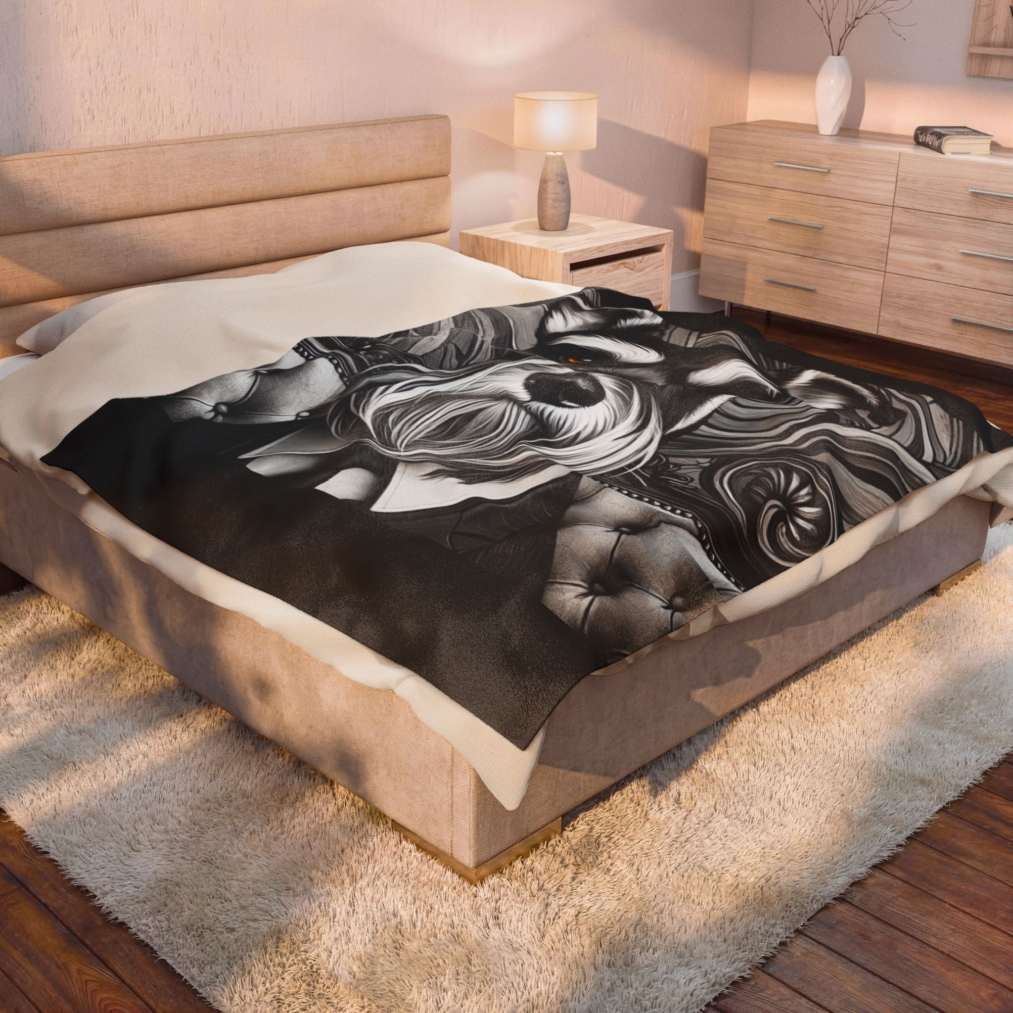 A bed in a styled bedroom setting, draped with a black throw blanket featuring a Schnauzer velveteen plush blanket featuring the "B&W Bold Gentleman" design with elegant black-and-white gentleman-inspired artwork.

