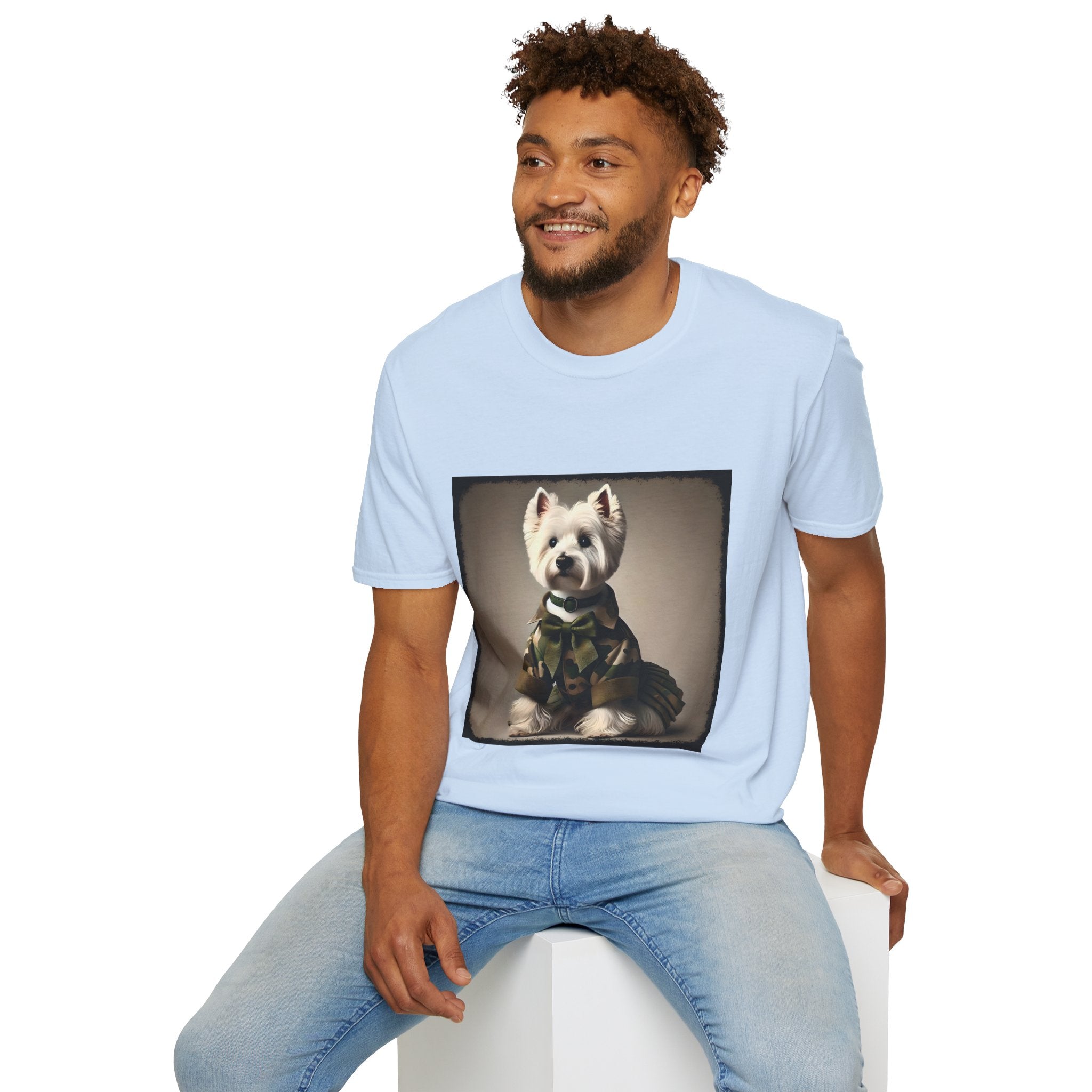 Male model in light blue dog t-shirt featuring Westie in camouflage jacket and pleated skirt against neutral backdrop.