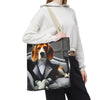 A person wearing a white hoodie and black sweatpants carries a canvas tote bag over their shoulder. The bag features a printed graphic of a beagle dog dressed in a black tuxedo and bow tie sitting in a gray car interior.