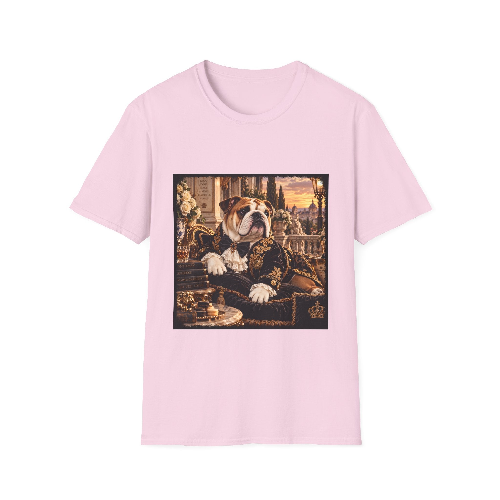 A light pink short-sleeve crewneck t-shirt featuring a square graphic print on the front. The graphic depicts an elegant bulldog dressed in a dark ornate coat, sitting on a throne with a golden sunset background.