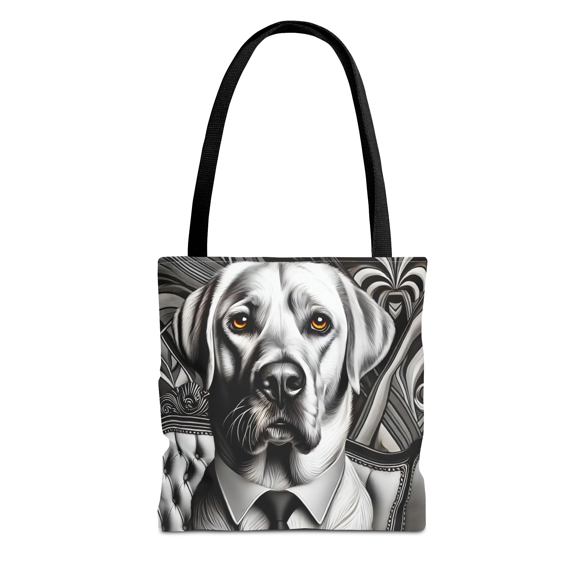 A tote bag featuring a black and white graphic illustration of a Labrador retriever wearing a suit and tie, with the dog's eyes highlighted in orange, and black shoulder straps, shown against a plain white background.