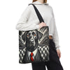 A person wearing a white cropped hoodie and black pants carries a black shoulder tote bag featuring a detailed graphic print of a black Labrador Retriever dressed in a suit with a red tie, set against a plain white background.