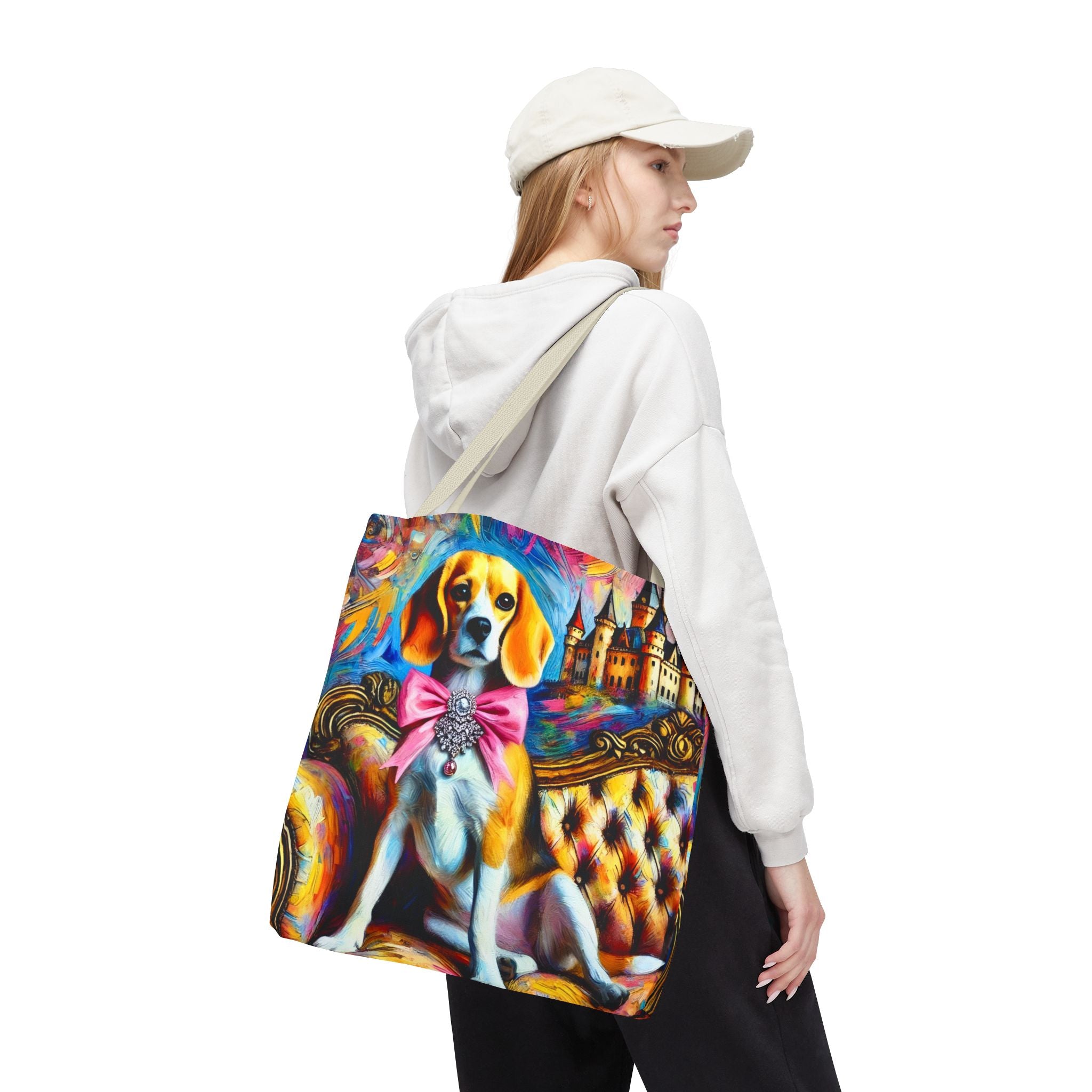 A woman wearing a white cap and white hoodie carries a large canvas tote bag with a colorful, stylized painting of a beagle wearing a pink bow tie, set against a plain white background.