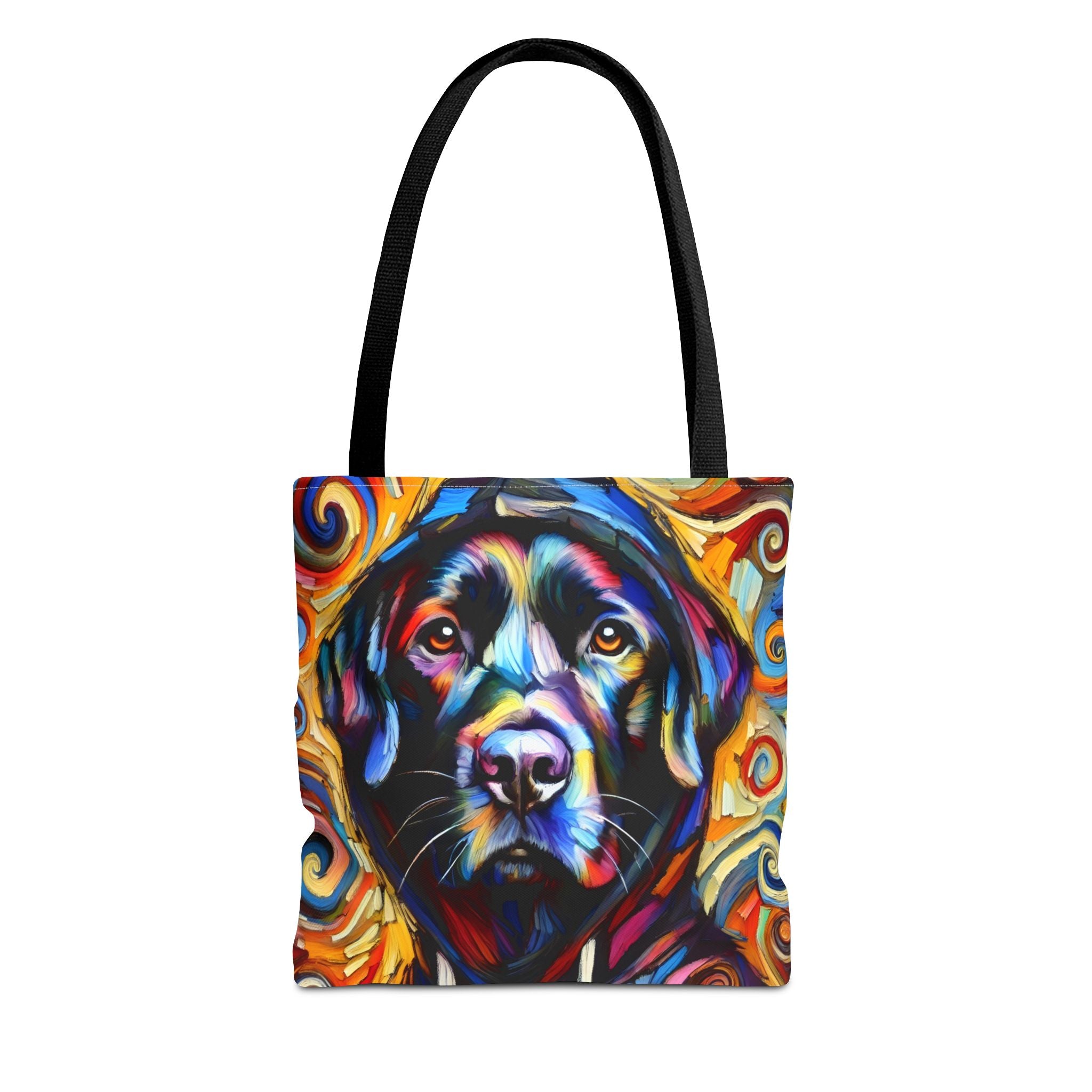 A tote bag with black handles featuring a colorful, stylized portrait of a black Labrador retriever surrounded by swirling abstract patterns in red, orange, yellow, blue, and white, shown on a plain white background.