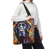 A person carries a large tote bag with a colorful painted black Labrador retriever portrait. The bag has a black shoulder strap and a vivid multicolor print featuring blue, yellow, orange, red, and black tones.