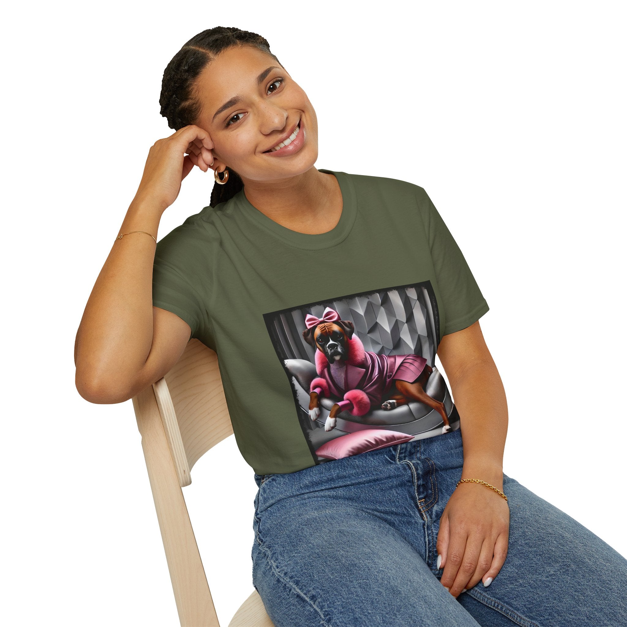 Female model in military green dog t-shirt featuring boxer in pink bow and pleated pink coat lounging on silver settee.