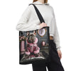 A model wearing a white cropped hoodie and black pants carries a black tote bag featuring a printed graphic of a French Bulldog in a pink jacket.