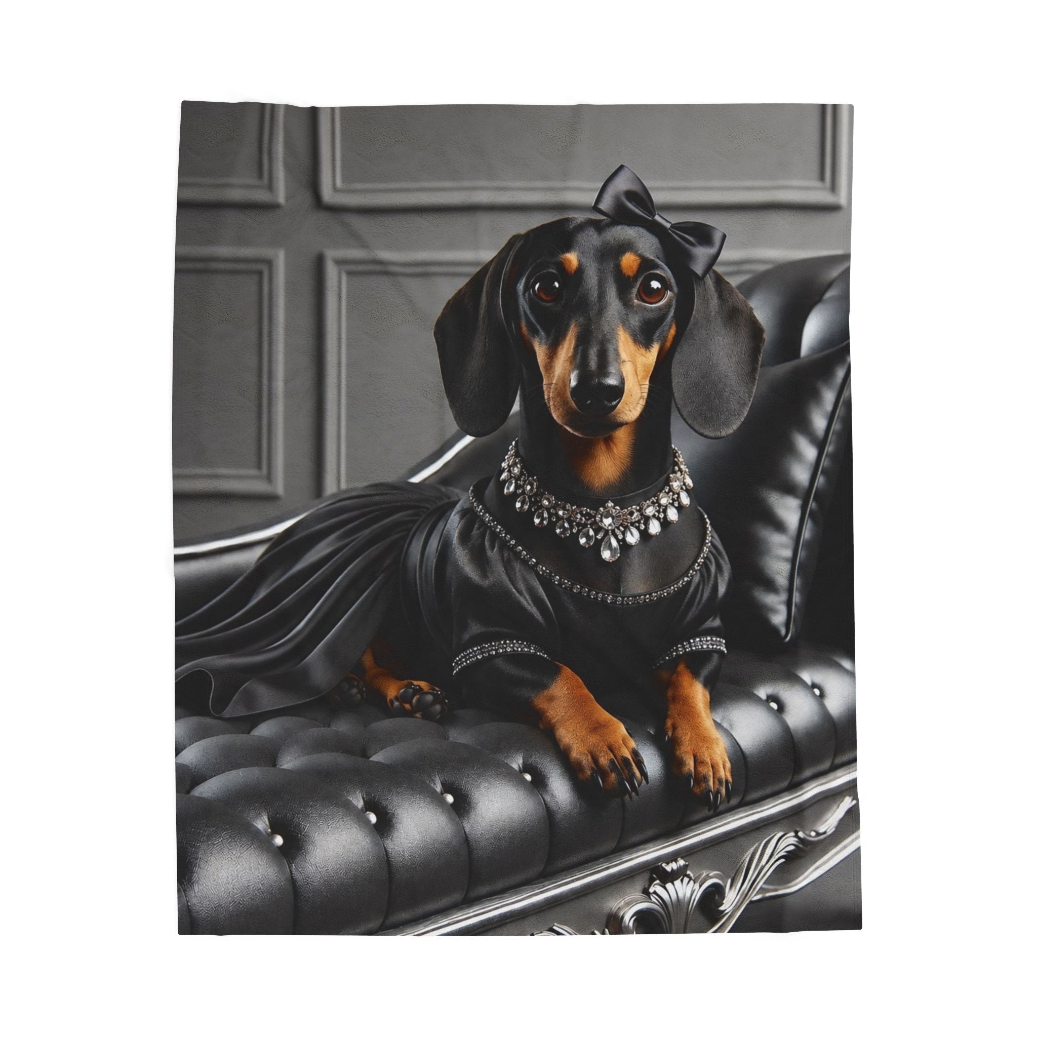 A square blanket featuring a dachshund dressed in a black satin gown with a jeweled collar and bow, posed on a black tufted chaise lounge against a gray paneled background.