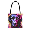 A tote bag with black shoulder straps, featuring a colorful printed graphic of a black Labrador's face with a pink bow on a yellow background.
