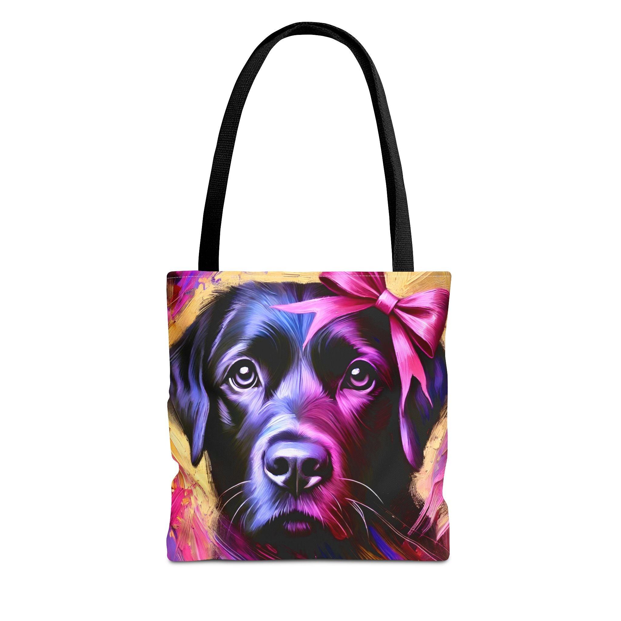 A tote bag with black shoulder straps, featuring a colorful printed graphic of a black Labrador's face with a pink bow on a yellow background.