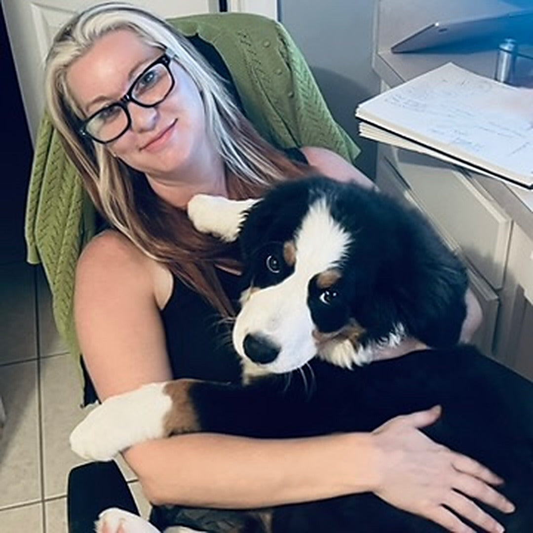 Stevie holding Belle, her Bernese Mountain Dog, the inspiration behind Breed & Thread